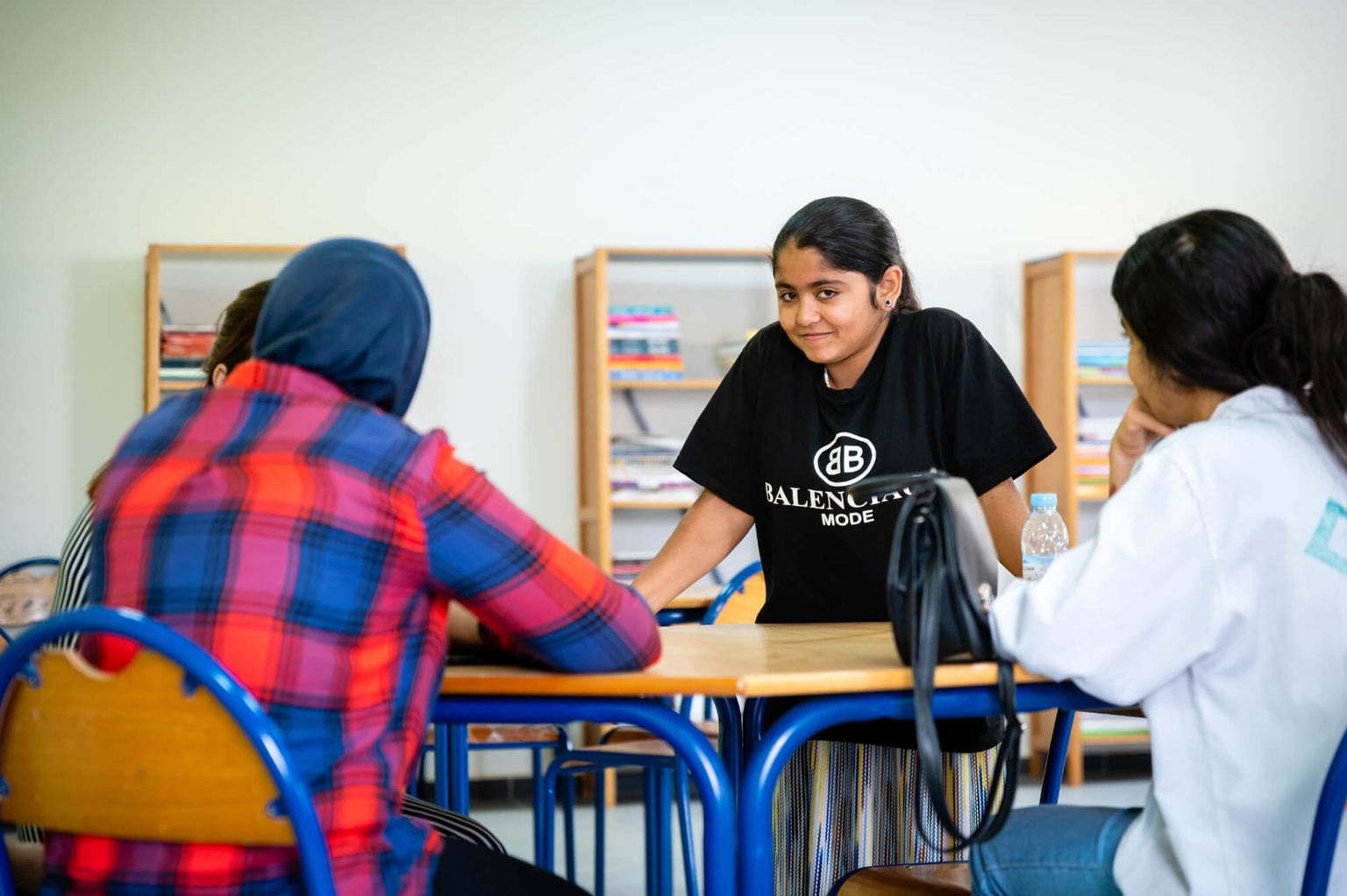 Ghizlan with her friends in the library of the Training and Integration Center for Youth.