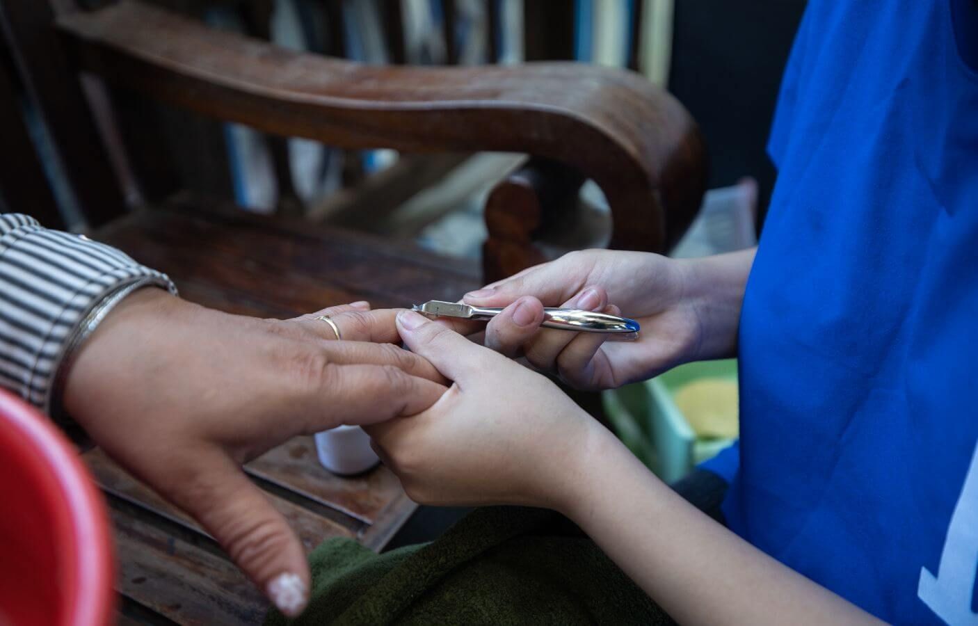 In her salon, Ngan gives a regular client a manicure.