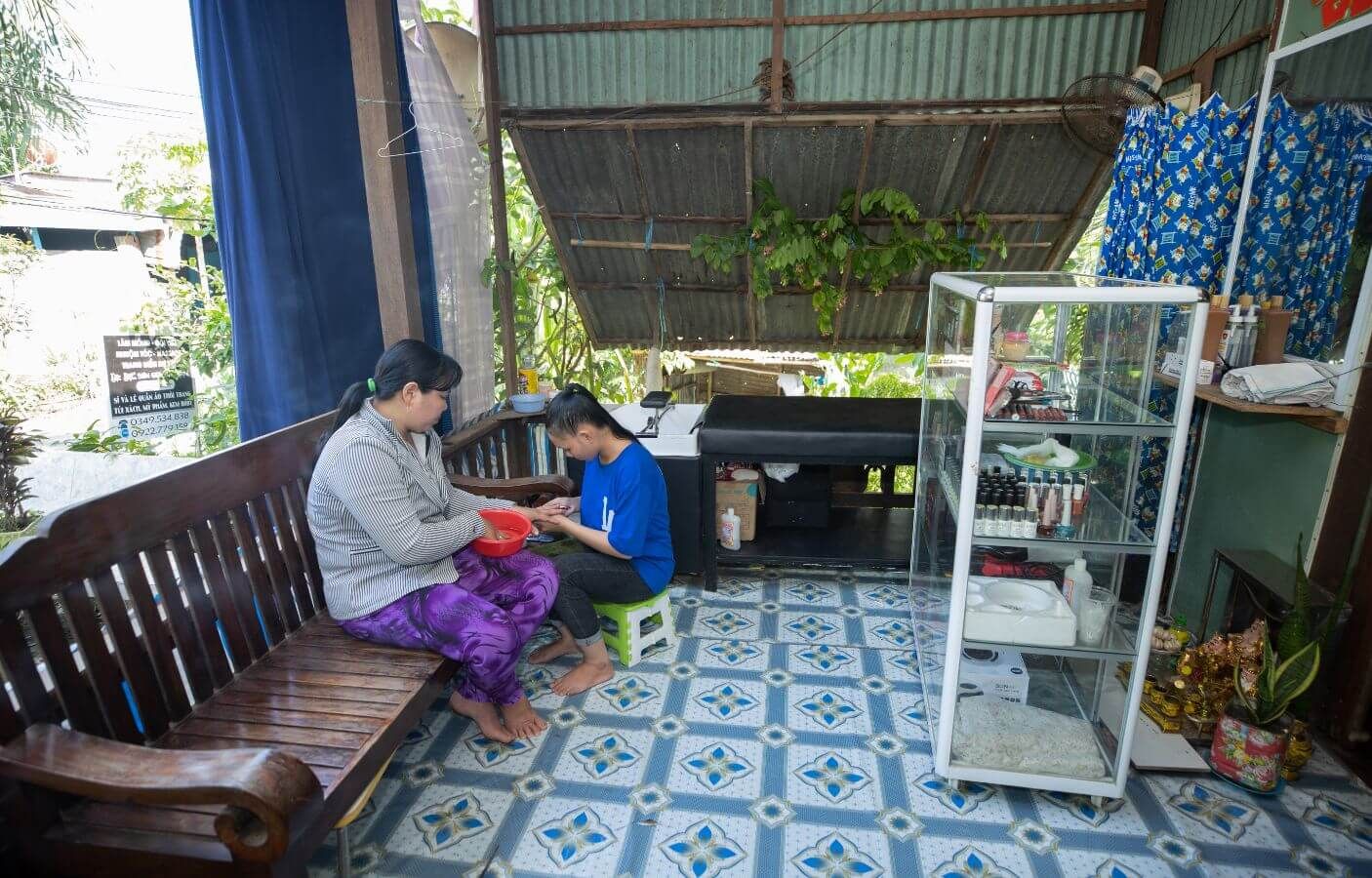 In her salon, Ngan gives a regular client a manicure.