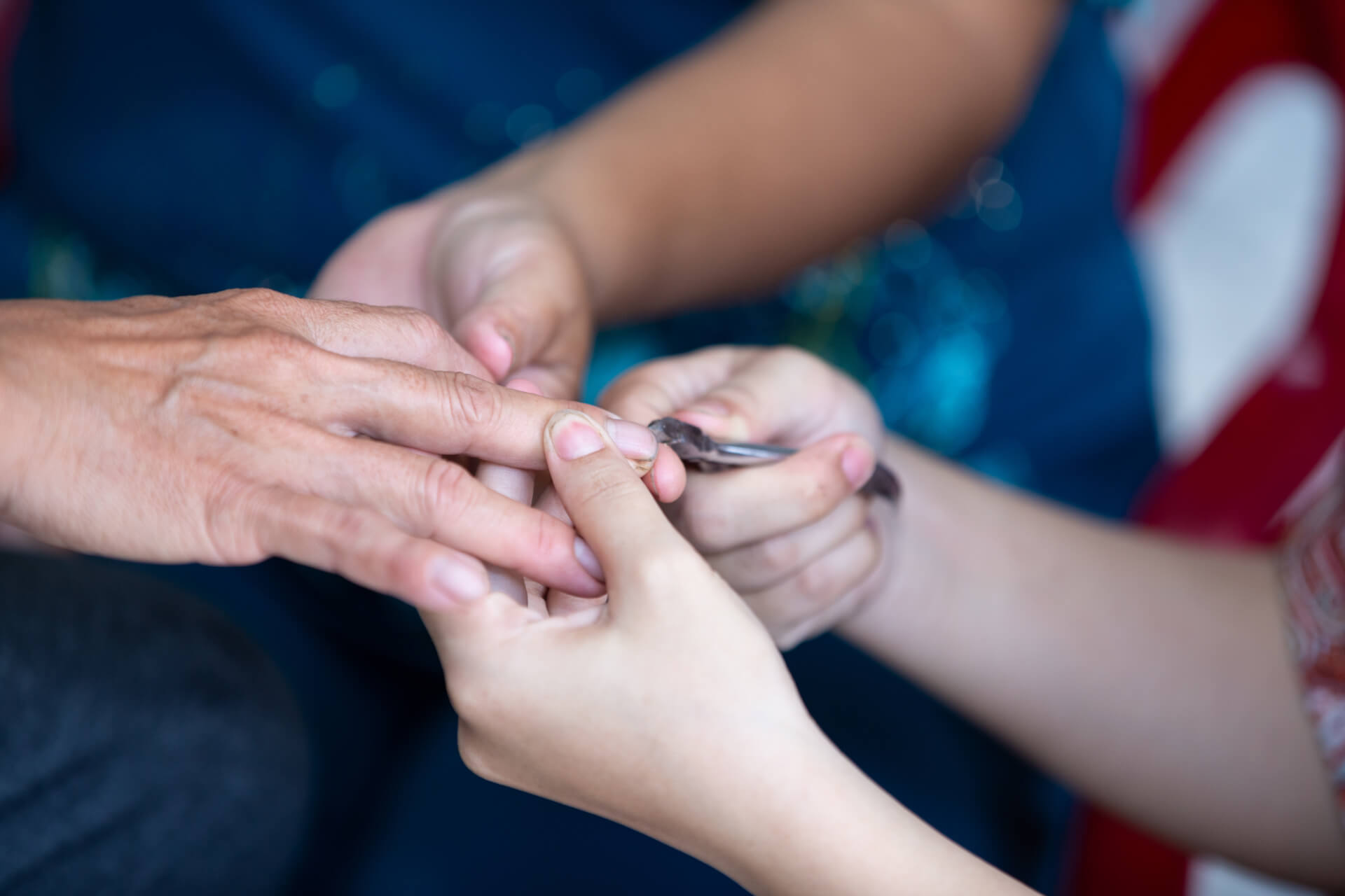 A salon owner guides Ngan on how to care for nails during her vocational training.